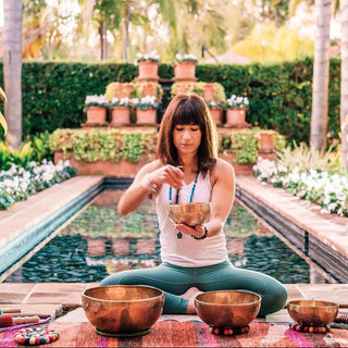 Woman with singing bowls at Rancho Valencia Resort and Spa